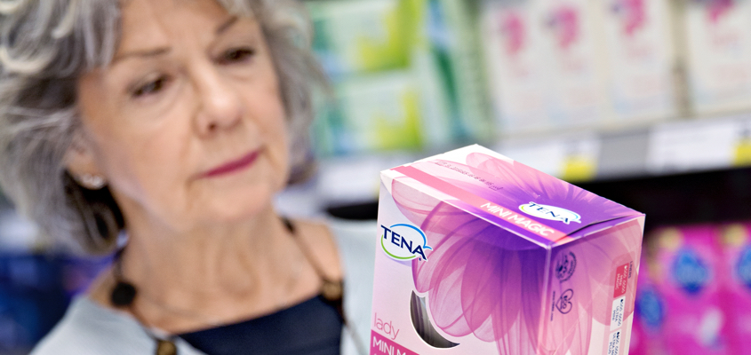 Wome looking at a Tena sanitary product (photo)